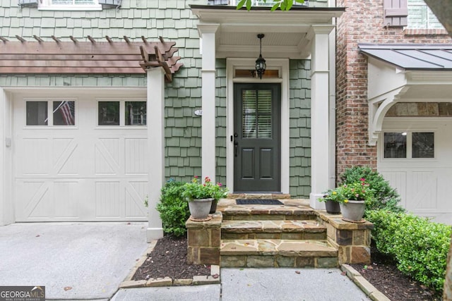 entrance to property with a garage and concrete driveway