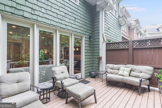 wooden terrace featuring fence and outdoor lounge area