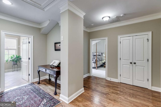 entrance foyer featuring ornamental molding, baseboards, and light wood finished floors