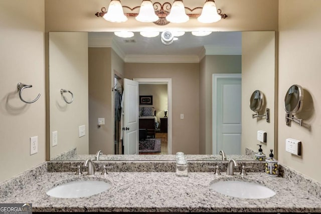 full bathroom with double vanity, ornamental molding, and a sink