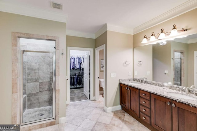 full bathroom featuring crown molding, visible vents, a sink, and a shower stall