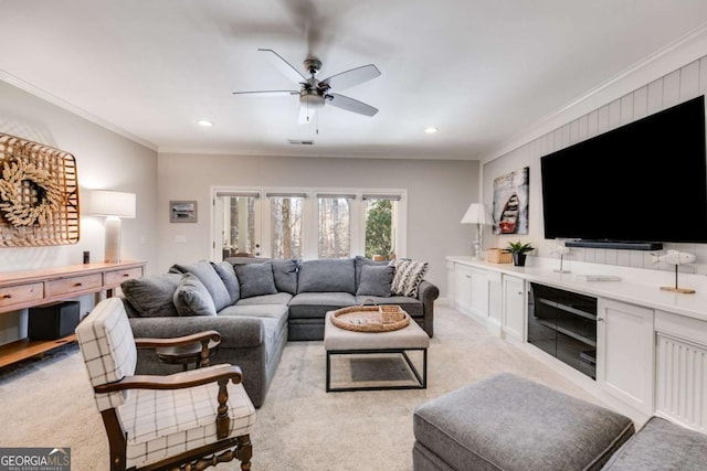 living room with light carpet, visible vents, a ceiling fan, ornamental molding, and recessed lighting