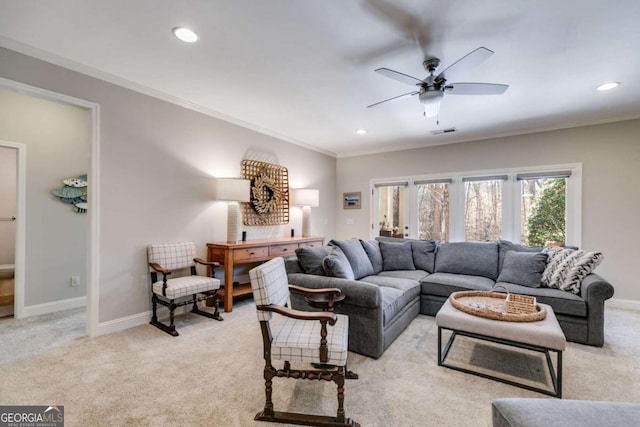 living room featuring ornamental molding, light colored carpet, visible vents, and baseboards