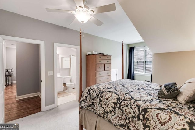 bedroom featuring a ceiling fan, light carpet, connected bathroom, and baseboards