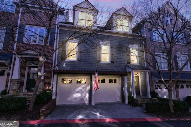 view of front of house with a garage and concrete driveway