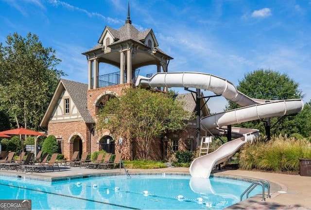 community pool featuring a water slide