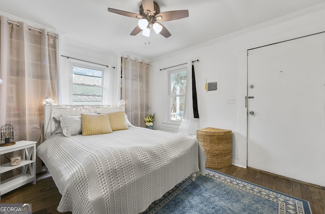 bedroom with a ceiling fan, wood-type flooring, and crown molding