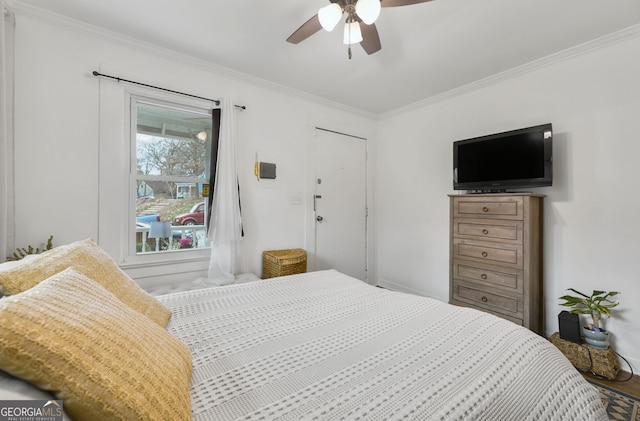 bedroom with ornamental molding, wood finished floors, and a ceiling fan