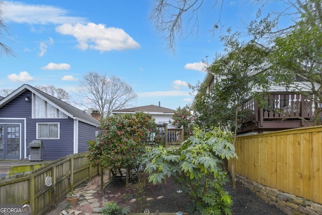 view of yard with a fenced backyard and a wooden deck