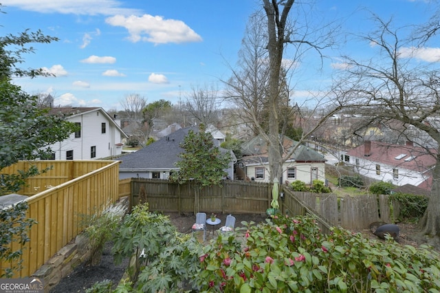 view of yard featuring a fenced backyard and a residential view