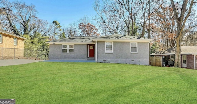 view of front facade featuring crawl space, brick siding, fence, and a front lawn