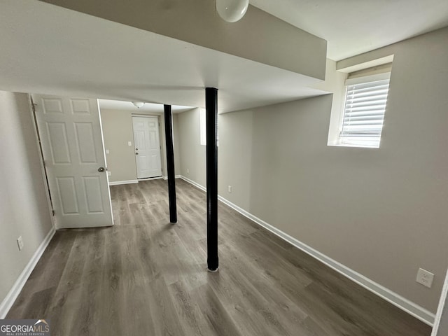 below grade area with wood finished floors and baseboards