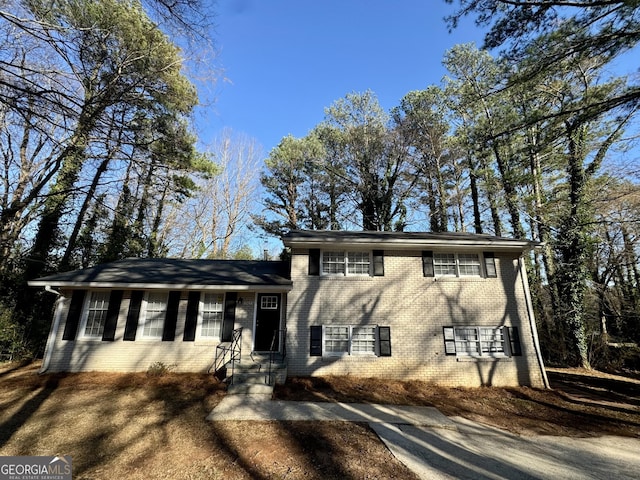 tri-level home with brick siding