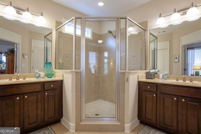 bathroom with a stall shower, tile patterned flooring, and vanity