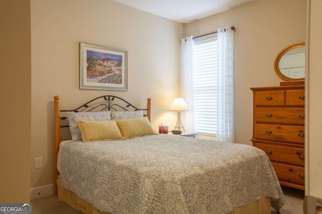 bedroom featuring baseboards and carpet flooring