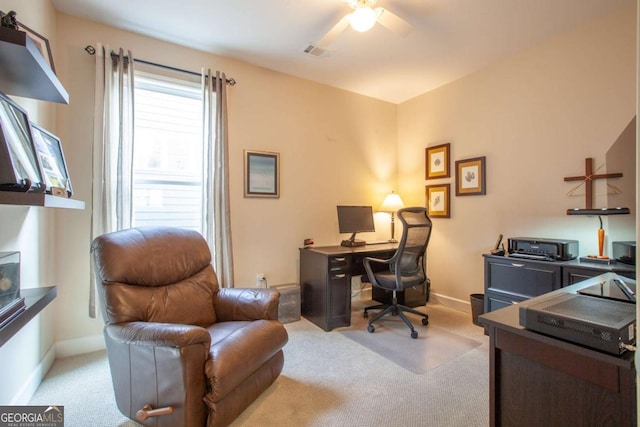 office space featuring a ceiling fan, light carpet, visible vents, and baseboards