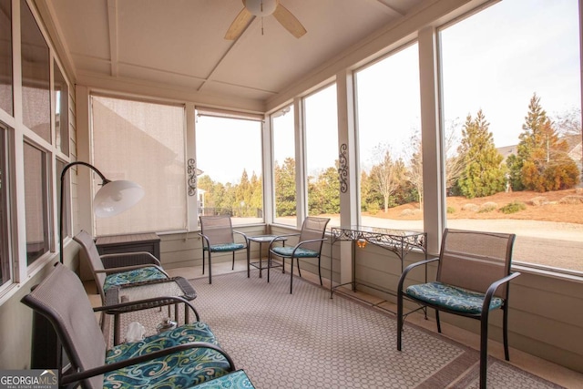 sunroom / solarium featuring ceiling fan