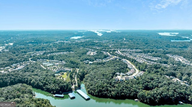 drone / aerial view featuring a water view and a view of trees