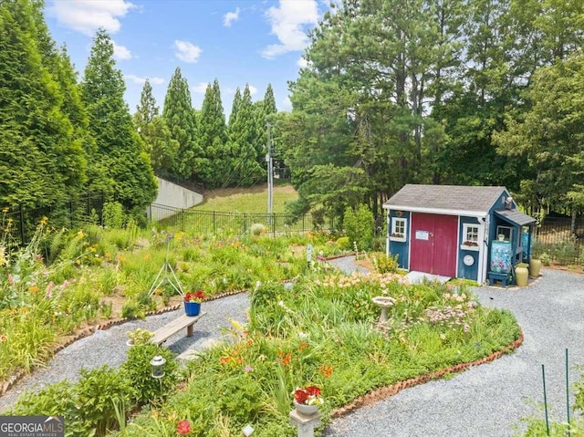 exterior space featuring a storage shed, fence, and an outdoor structure