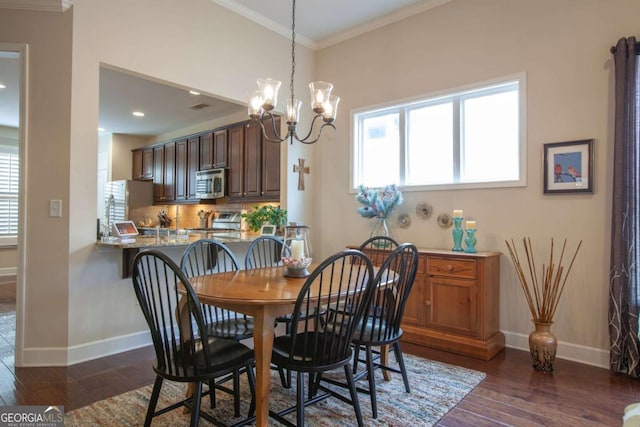 dining space featuring ornamental molding, dark wood-type flooring, plenty of natural light, and baseboards