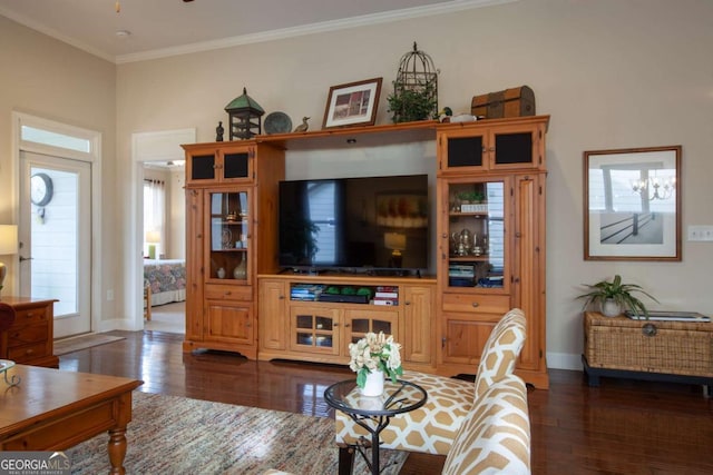 living area with dark wood-style floors, ornamental molding, baseboards, and ceiling fan