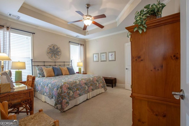 bedroom featuring ornamental molding, carpet floors, a tray ceiling, and visible vents