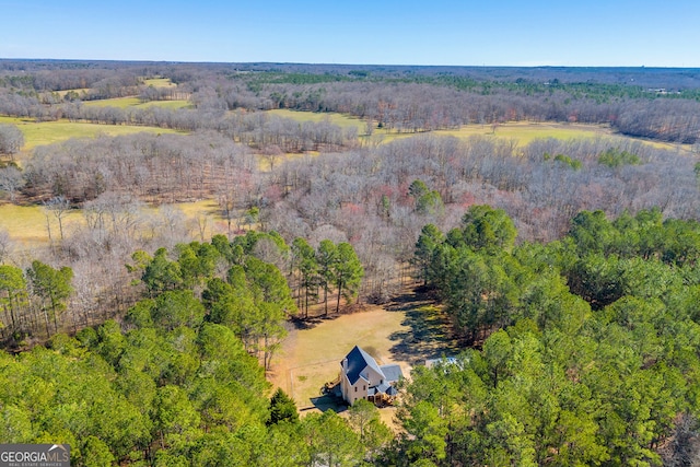 bird's eye view featuring a wooded view and a rural view