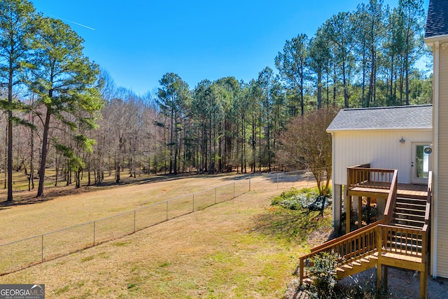 view of yard featuring a fenced backyard, stairs, and a wooden deck