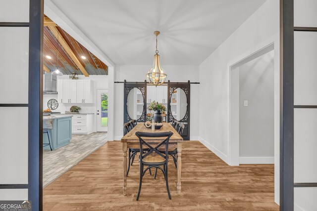 599 Double Branch Rd, Danielsville, GA 30633 - dining space featuring light wood-style floors, a chandelier, baseboards, and a barn door