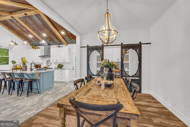 599 Double Branch Rd, Danielsville, GA 30633 - dining room with a barn door, a chandelier, light wood finished floors, and baseboards