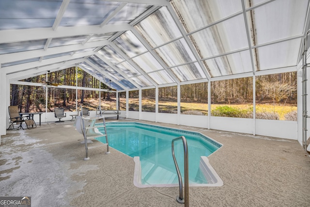 pool featuring a patio area and glass enclosure