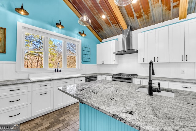 kitchen with stainless steel gas stove, dishwasher, wall chimney range hood, white cabinetry, and a sink