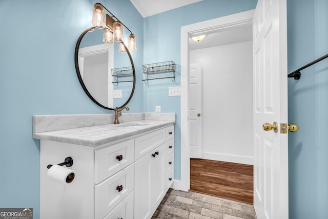 bathroom featuring baseboards and vanity