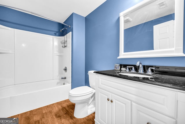 full bath with visible vents, toilet, wood finished floors, tub / shower combination, and vanity