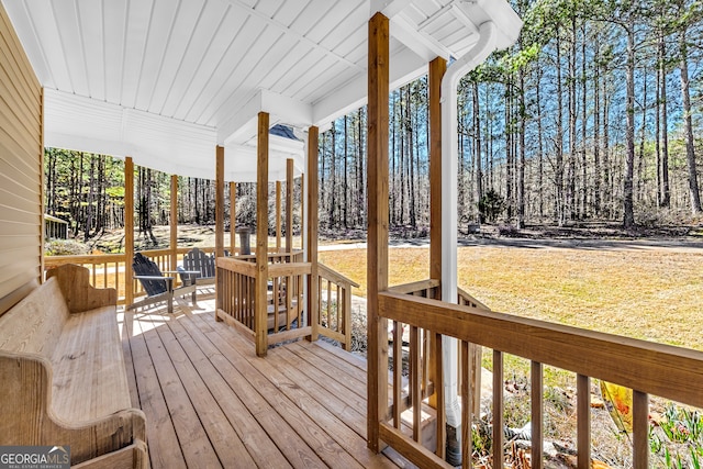 599 Double Branch Rd, Danielsville, GA 30633 - deck featuring a porch, a lawn, and view of wooded area