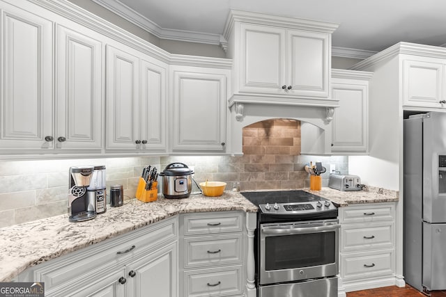 kitchen with crown molding, custom exhaust hood, decorative backsplash, appliances with stainless steel finishes, and white cabinetry