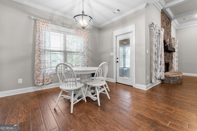 dining area with a stone fireplace, wood finished floors, visible vents, and crown molding