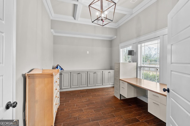 office area featuring wood finish floors, ornamental molding, a chandelier, coffered ceiling, and beamed ceiling