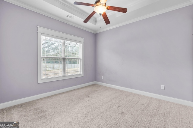 spare room featuring carpet floors, baseboards, a tray ceiling, and crown molding