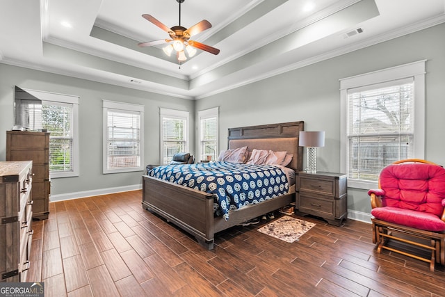 bedroom with wood tiled floor, baseboards, and a raised ceiling