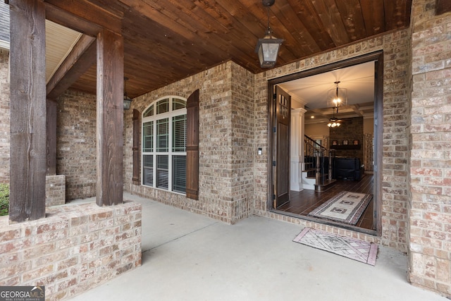 entrance to property featuring brick siding