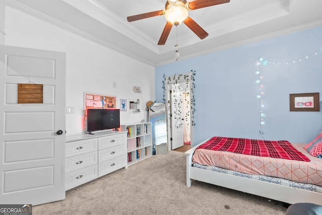 bedroom with ceiling fan, a raised ceiling, crown molding, and light colored carpet