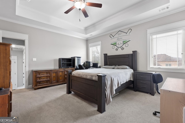 bedroom featuring ornamental molding, a raised ceiling, visible vents, and light carpet