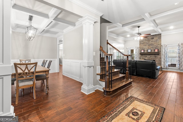 dining area with coffered ceiling, ceiling fan, stairway, wood finish floors, and ornate columns