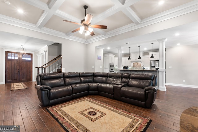 living room featuring beam ceiling, coffered ceiling, dark wood finished floors, and ornate columns