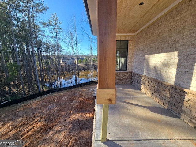 view of patio with a water view