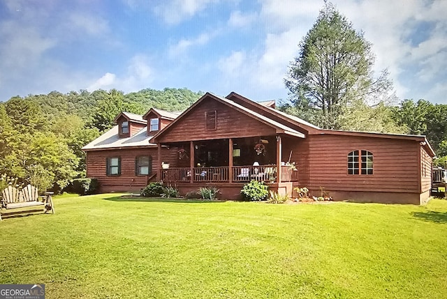 back of house featuring a yard and a porch