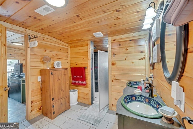 full bathroom with wooden walls, visible vents, wood ceiling, marble finish floor, and a stall shower