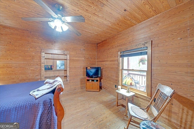 bedroom featuring wooden ceiling, ceiling fan, wooden walls, and wood finished floors