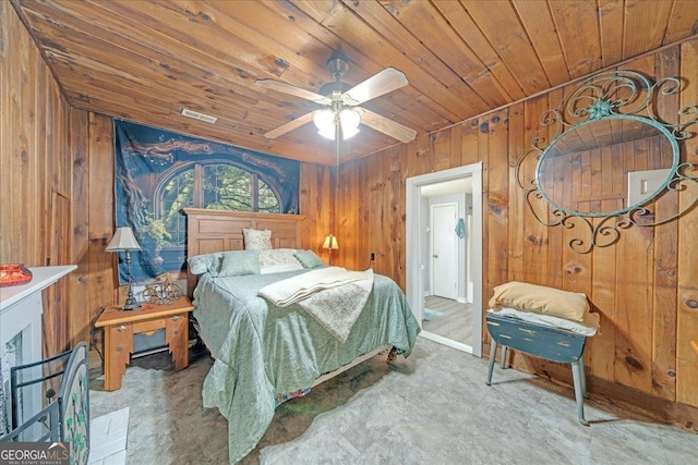 bedroom featuring a ceiling fan, wooden ceiling, visible vents, and wood walls